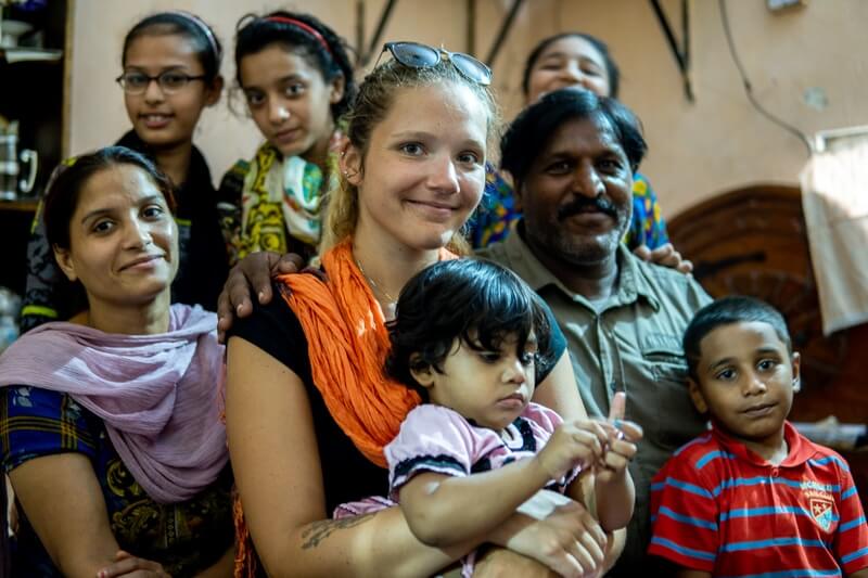 girl holding baby with family