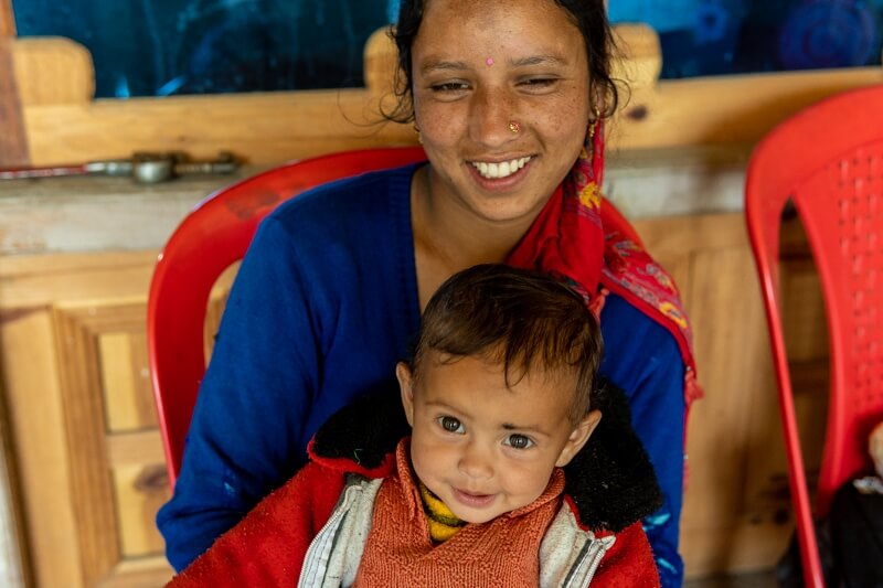 mother and son sitting in chair