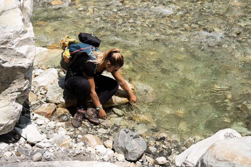 girl filling up water bottle from grahan nallah