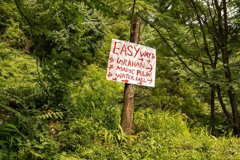 white sign with red writing on the way to grahan