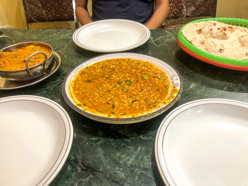 dal maash and naan sitting on green table